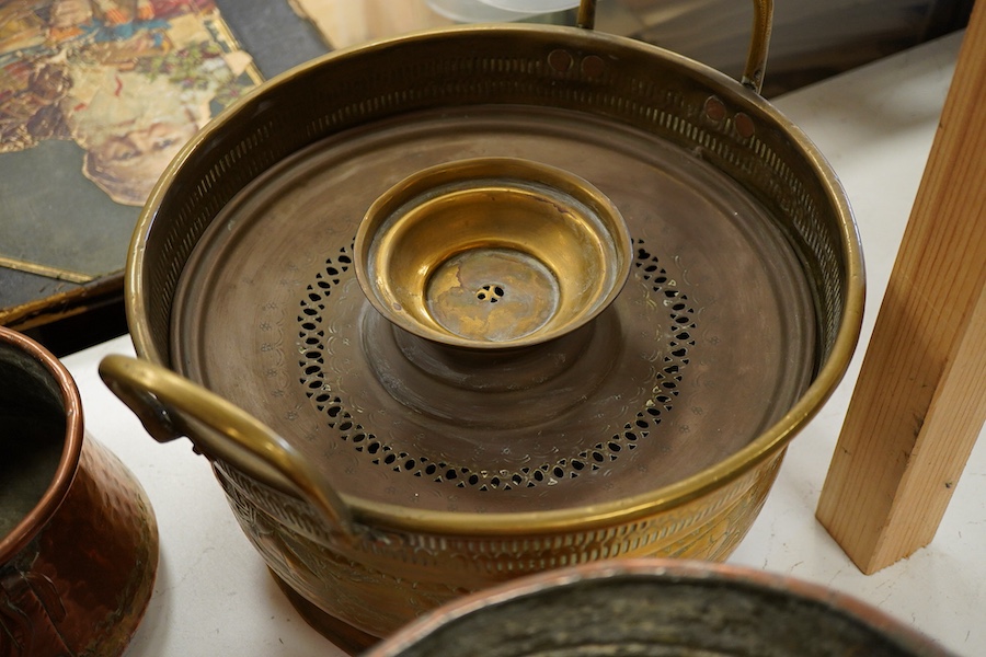 A collection of four copper vessels and another brass, largest 32cm
